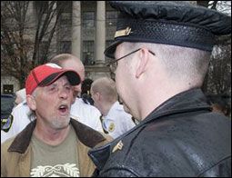 People struggle against the wind and rain in Malmö, Sweden, after a storm reached southern Sweden, Saturday Oct. 4, 2025. (Johan Nilsson/TT via AP)